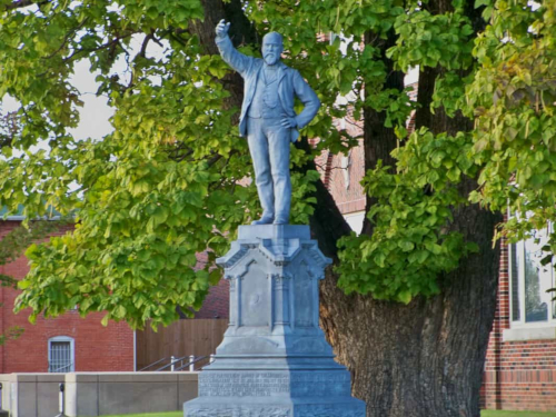 Decorative picture of a founding father statue in front of the courthouse